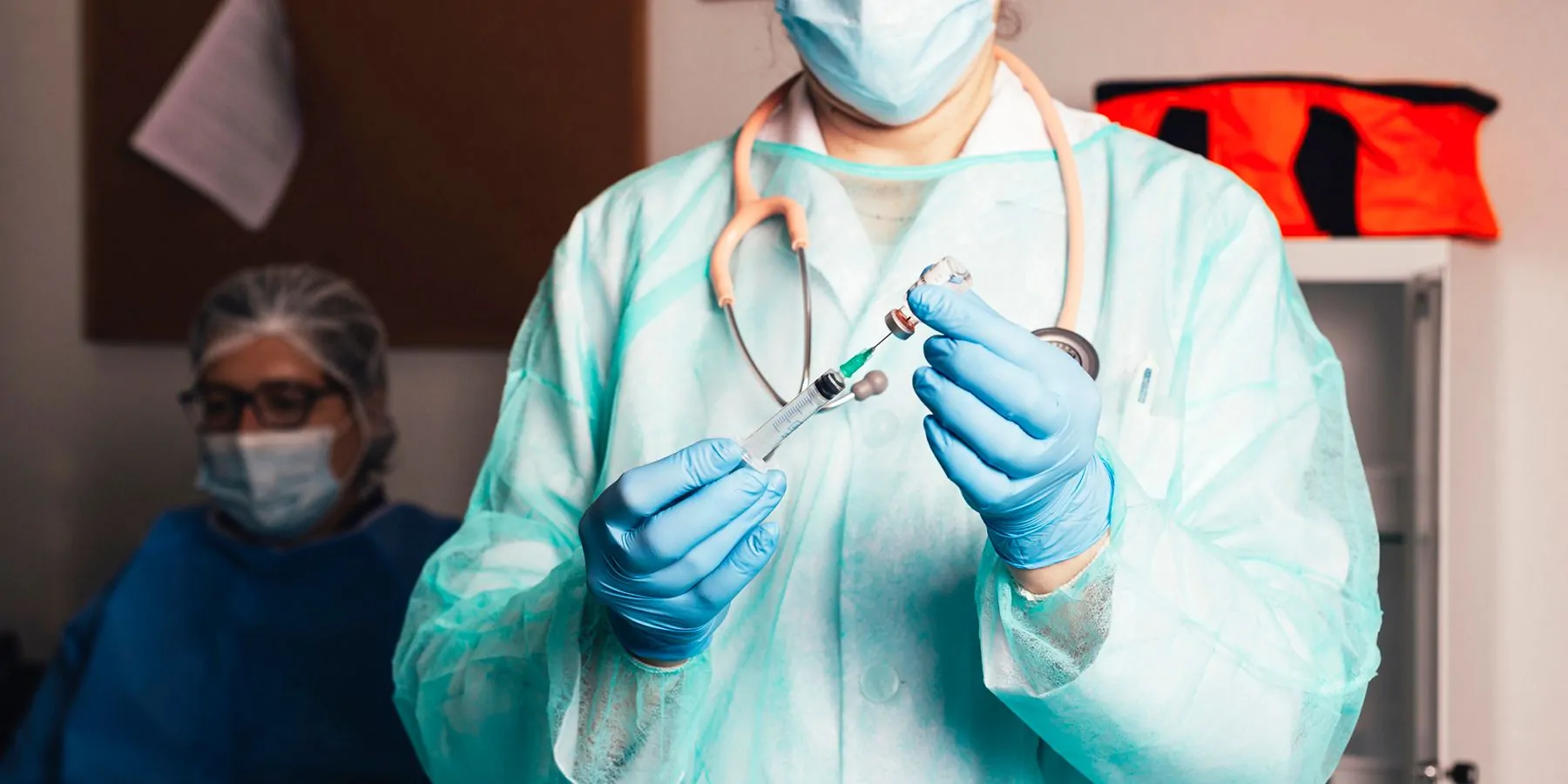 Photograph of health care worker carrying out a molecular test immediately with their patient in the room. 
