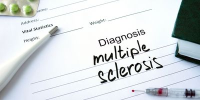 A paper with "Multiple Sclerosis" written on it with a needle and thermometer