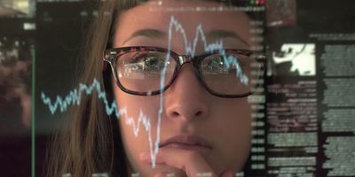 Woman concentrating on a touch screen display to look at data for real-time monitoring of the lab environment.  