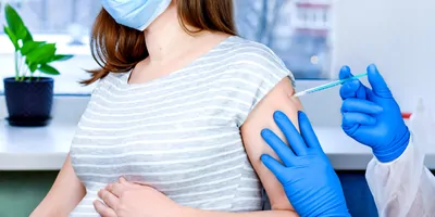 Pregnant women getting vaccinated for COVID-19 in the arm