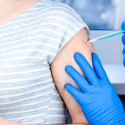 Pregnant women getting vaccinated for COVID-19 in the arm