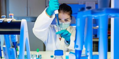 Photograph of a researcher handling patient samples prior to performing a diagnostic PCR test.