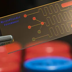 microfluidic processor, lab on chip, being held by tweezers