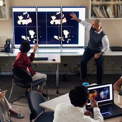 Photo of a clinical laboratory professional giving a presentation to high school students.