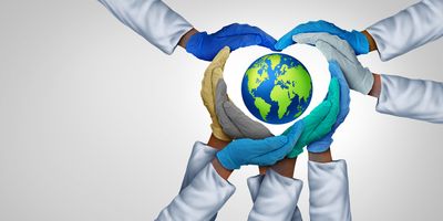 Gloved hands making a heart shape around a globe