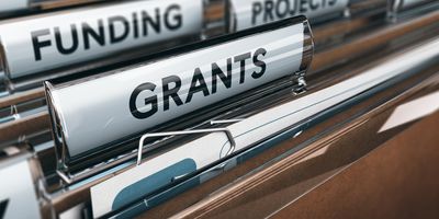 File folders with the words "Grants" and "Funding" written on them