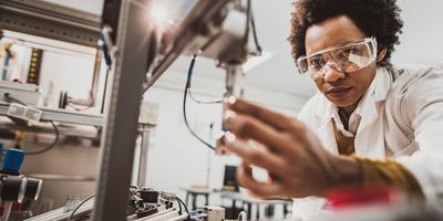 Photograph of a researcher working with a clinical analyzer that uses purified water.