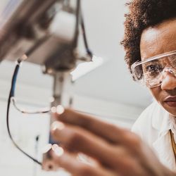 Photograph of a researcher working with a clinical analyzer that uses purified water.