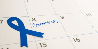 Colonoscopy appointment marked on the calendar during March, which is Colon Cancer Awareness month represented by the blue ribbon
