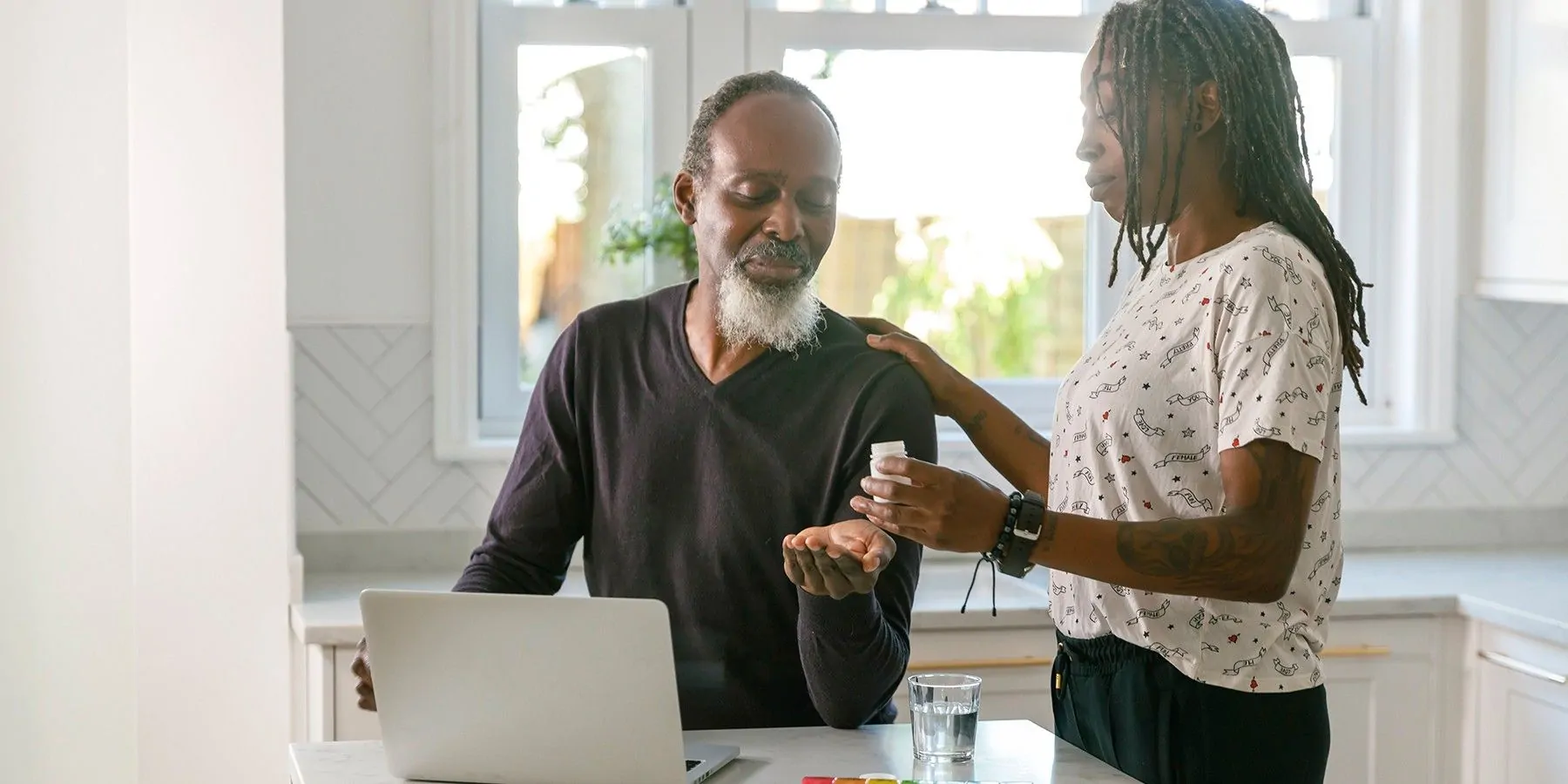 Photograph of a person completing his cognitive assessment and taking medications given by his caregiver as he recovers from COVID-19 months after infection. 
