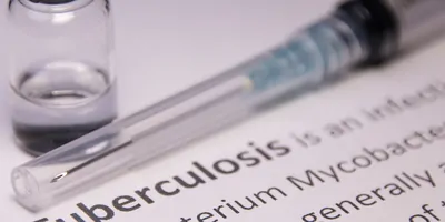 A needle and medication on a piece of paper that says Tuberculosis