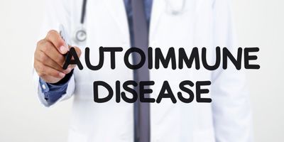 Doctor writing "Autoimmune Disease" in black marker on a window