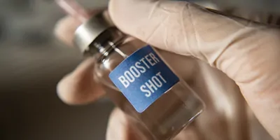 Vaccine booster being drawn from a bottle