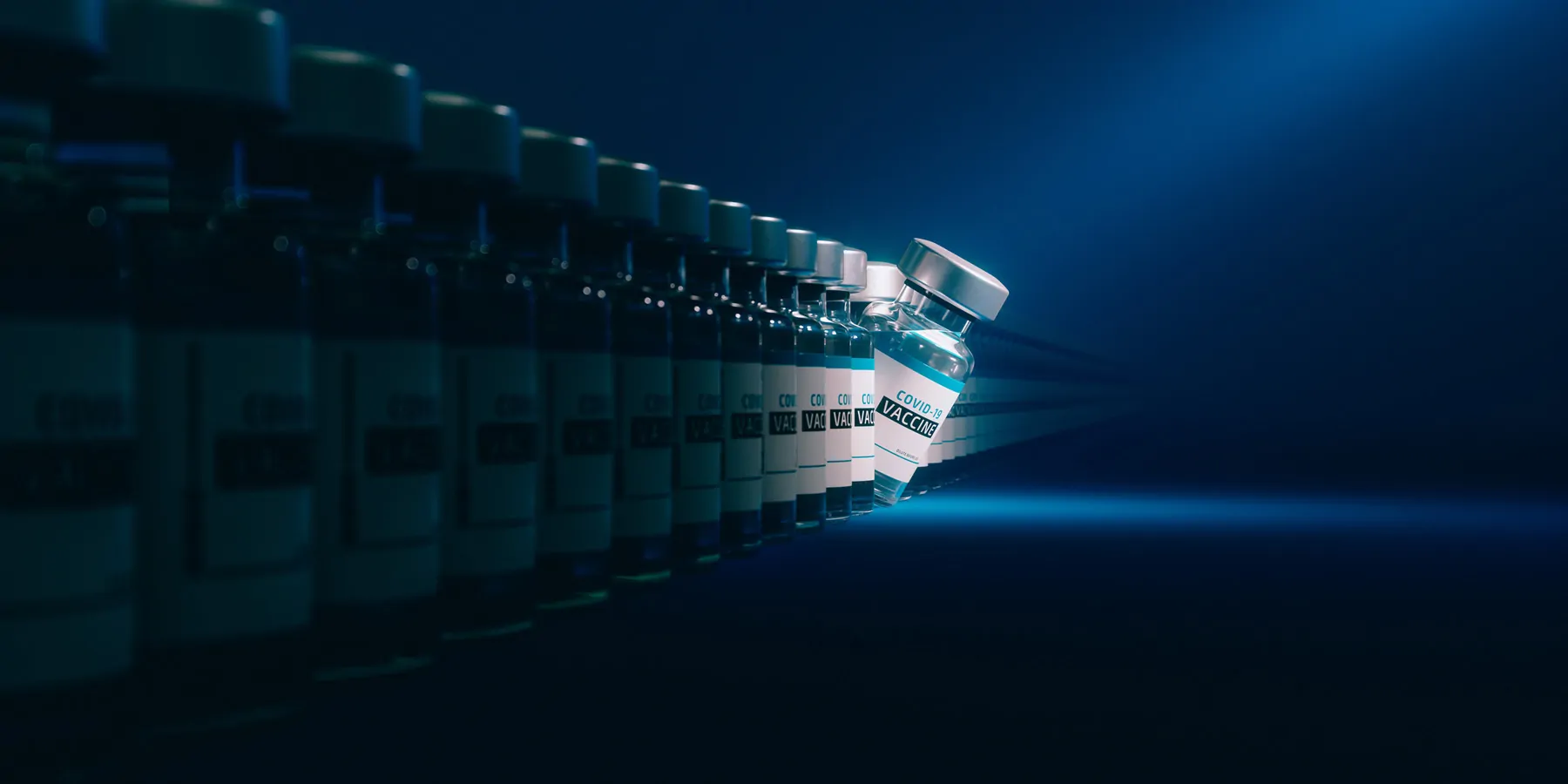 Line of vaccine bottles with a spotlight on one of them