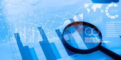 Magnifying lense on a paper with charts