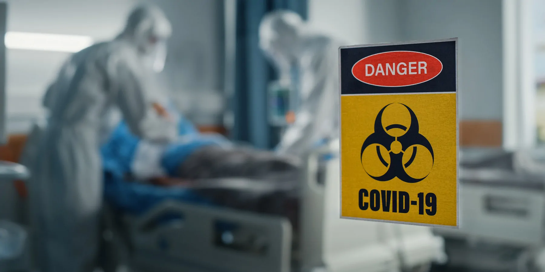 Health care professionals in full PPE working in a COVID-19 ward