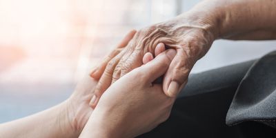 Two people holding hands