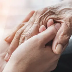Two people holding hands