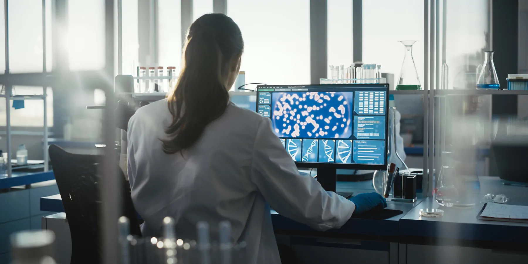 Researcher working at a computer in a lab