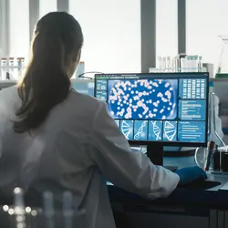 Researcher working at a computer in a lab