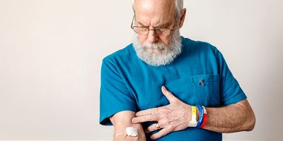 Older gentleman, cancer survivor showing arm where he got a blood test