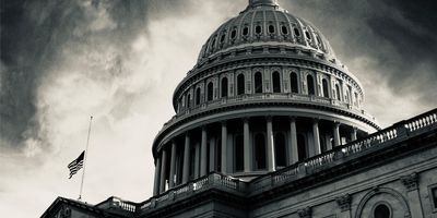 Photo of the US Capitol Building in greyscale with ominous clouds.