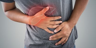 Man bending over with a red spot where his liver is