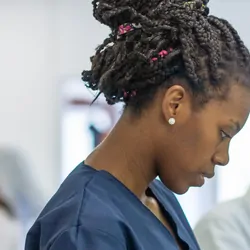 Photograph of clinical lab personnel working alongside automation in a clinical lab.