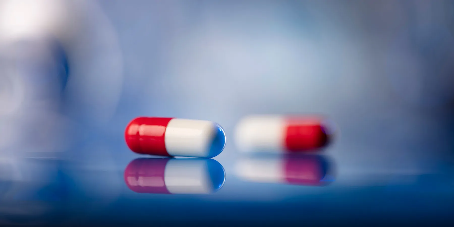 Red and white pills on a table