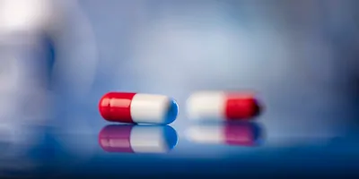 Red and white pills on a table