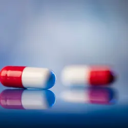 Red and white pills on a table