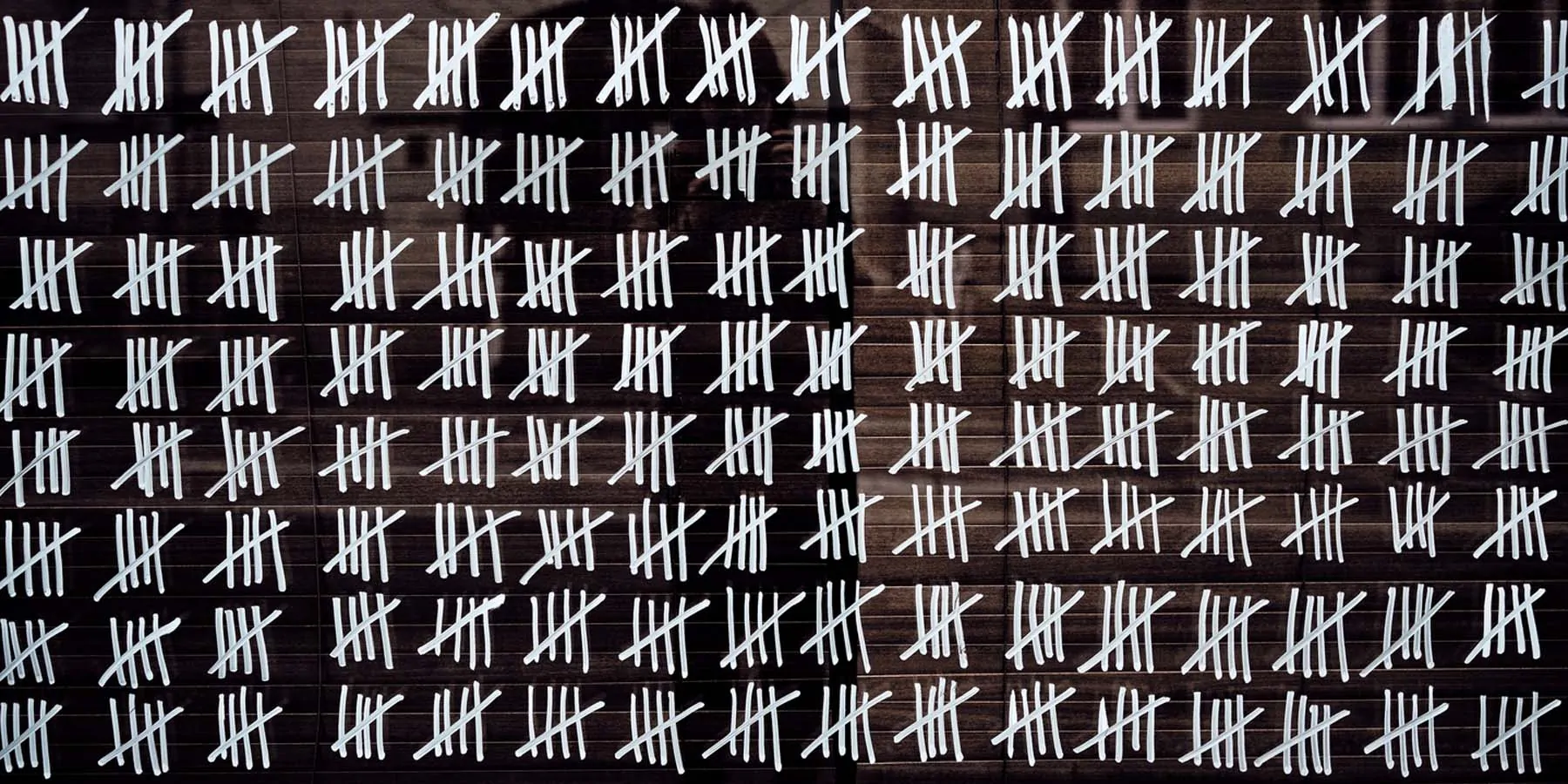 Photo of chalk marks on a chalk board making the days of long COVID.