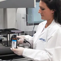 Photograph of lab personnel using automated liquid handlers for increased productivity.