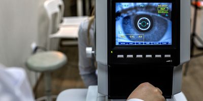 optometrist examining female patient in ophthalmology clinic