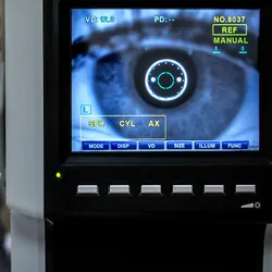 optometrist examining female patient in ophthalmology clinic