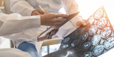 professional brain and neurological surgeon with digital tablet working in hospital clinic discussion