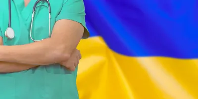 Male surgeon or doctor with stethoscope on the background of the Ukraine flag