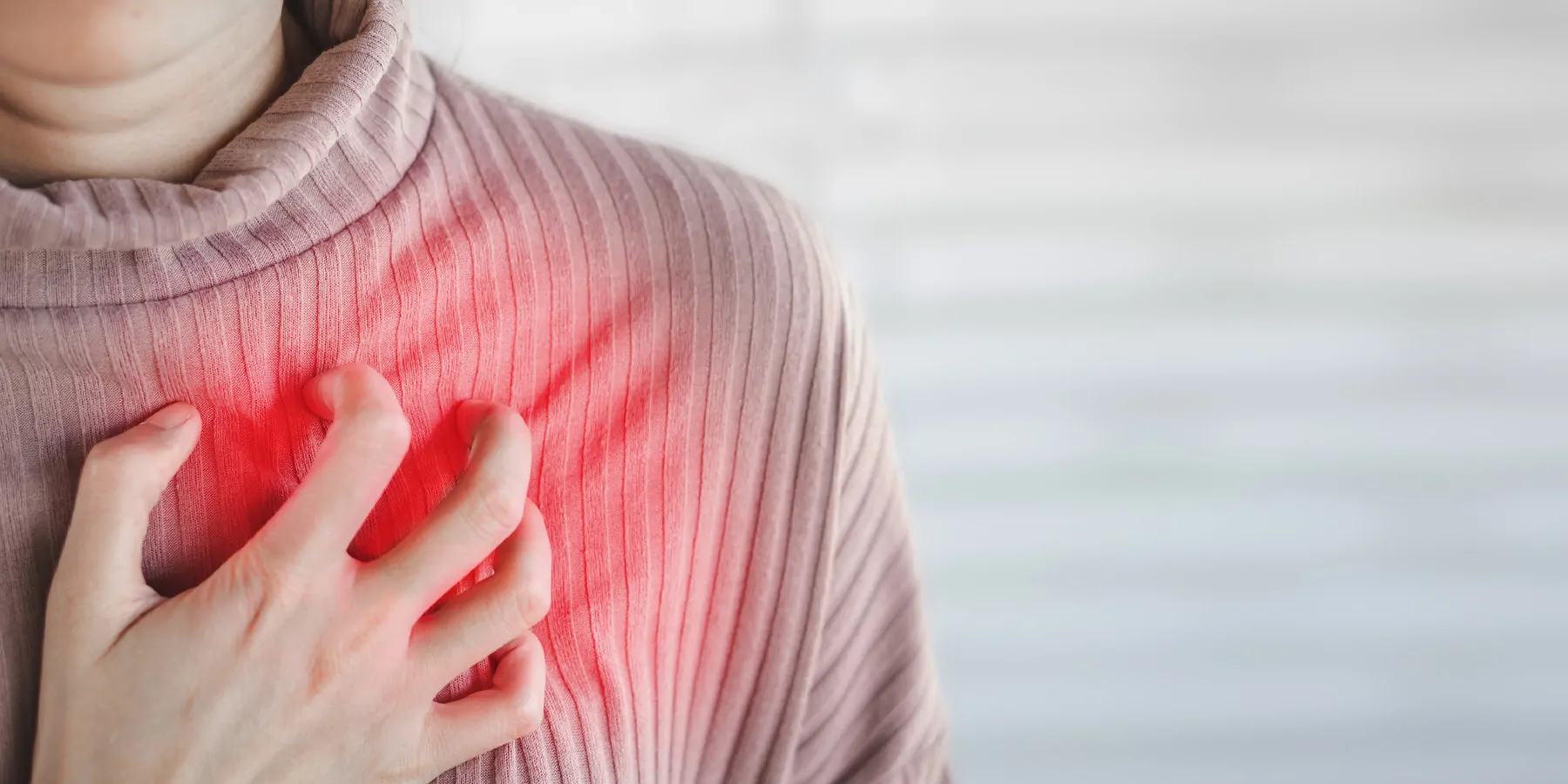 woman hand touching her chest having heart attack