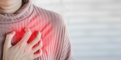woman hand touching her chest having heart attack