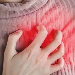 woman hand touching her chest having heart attack