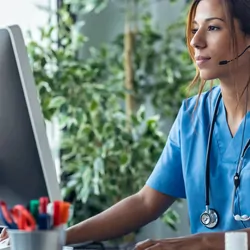 Shot of female doctor talking with earphone while explaining medical treatment to patient through a video call