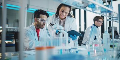 Researchers using a microscope in lab