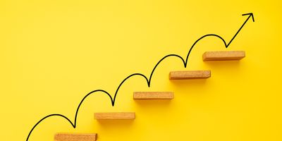 A representation of career growth showing an arrow between subsequent stairs.