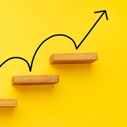 A representation of career growth showing an arrow between subsequent stairs.