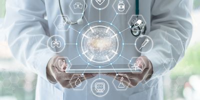 Doctor holding a tablet with holographic interface above