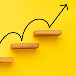 A representation of career growth showing an arrow between subsequent stairs.