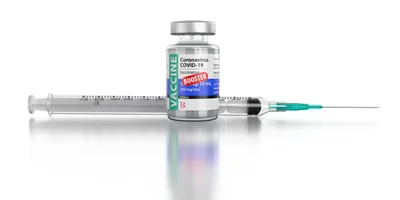 COVID-19 Vaccine Booster Vial and Syringe On White Background
