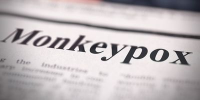 Photo of a newspaper head that reads "Monkeypox."