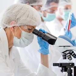 Scientists in protective gear in a clinical laboratory