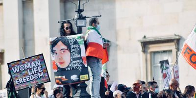Photograph of protesters carrying signs such as “Women, Life, Freedom” in support of women and human rights in Iran. 